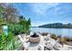 Relaxing fire pit with seating overlooking the water at 383 Aruba Cir # 101, Bradenton, FL 34209