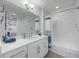Bathroom with single vanity, tub shower combination, and white cabinets at 383 Aruba Cir # 101, Bradenton, FL 34209