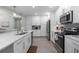 Modern kitchen with white cabinets, stainless steel appliances and an island at 383 Aruba Cir # 101, Bradenton, FL 34209