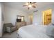 Spacious bedroom with king-size bed, dresser, armchair, and access to bathroom at 383 Aruba Cir # 101, Bradenton, FL 34209