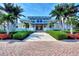 Elegant clubhouse entrance with landscaping and brick walkway at 383 Aruba Cir # 101, Bradenton, FL 34209