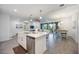 Open concept kitchen with island, white cabinets and stainless steel appliances at 383 Aruba Cir # 101, Bradenton, FL 34209