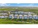 Aerial view showing a collection of waterfront buildings and green spaces at 383 Aruba Cir # 101, Bradenton, FL 34209