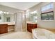 Elegant bathroom with double vanities, soaking tub, and a separate shower at 235 Dahlia Ct, Bradenton, FL 34212