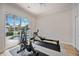 Home gym with an air bike and rowing machine, overlooking the pool area at 302 Americas Cup Blvd, Bradenton, FL 34208