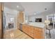 Open kitchen features light wood cabinets, stainless steel appliances, and a granite breakfast bar at 302 Americas Cup Blvd, Bradenton, FL 34208