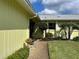 Side yard with walkway, shrubs, and trees at 6812 11Th W Ave # 6812, Bradenton, FL 34209