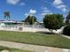 Community pool with surrounding grassy area and white fence at 6812 11Th W Ave # 6812, Bradenton, FL 34209