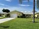 Inviting yellow home with lush landscaping and a two-car garage at 6812 11Th W Ave # 6812, Bradenton, FL 34209