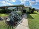 Neatly landscaped front yard with agave plants and a concrete path at 6812 11Th W Ave # 6812, Bradenton, FL 34209