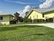 Landscaped yard with two pastel yellow houses visible at 6812 11Th W Ave # 6812, Bradenton, FL 34209