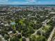 Aerial view of a residential area with tennis courts and a pond at 1663 4Th St, Sarasota, FL 34236