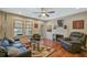 Living room with hardwood floors, fireplace and ceiling fan at 1663 4Th St, Sarasota, FL 34236