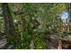 Peaceful backyard with tropical plants, statues and a shaded patio area at 1663 4Th St, Sarasota, FL 34236