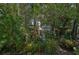 Private backyard with lush tropical landscaping and a patio seating area at 1663 4Th St, Sarasota, FL 34236