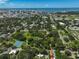 Aerial view of a residential area with tennis courts and a pond at 1663 4Th St, Sarasota, FL 34236