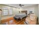 Bright bedroom with hardwood floors, a comfortable bed, and a relaxing armchair at 1663 4Th St, Sarasota, FL 34236