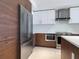 Modern kitchen with stainless steel appliances and wood cabinets at 111 S Pineapple Ave # 1009, Sarasota, FL 34236