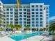 Resort-style pool with ample lounge chairs and lush landscaping at 111 S Pineapple Ave # 1009, Sarasota, FL 34236