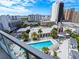 Balcony view of resort-style pool and city skyline at 111 S Pineapple Ave # 1009, Sarasota, FL 34236