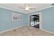 Bedroom with light blue walls, tile floors, and pool view at 225 Brighton Ct, Englewood, FL 34223