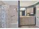 Bathroom featuring granite countertops, light cabinets, and a shower/tub at 225 Brighton Ct, Englewood, FL 34223