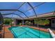 Inviting pool area with screened enclosure, spa, and ample space for relaxation at 225 Brighton Ct, Englewood, FL 34223