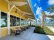 Charming outdoor dining patio with views of the waterfront and lush landscaping at 225 Brighton Ct, Englewood, FL 34223