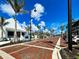 Quaint street with red brick road lined with palm trees and charming storefronts at 225 Brighton Ct, Englewood, FL 34223