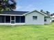 Backyard of a home with a screened-in porch and a well-manicured lawn at 5278 Sabrina Ter, North Port, FL 34286