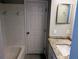 Bright bathroom with a granite countertop, tiled shower/tub, and a modern mirror at 5278 Sabrina Ter, North Port, FL 34286