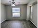 Bright bedroom with modern flooring, neutral paint, ceiling fan, and large windows at 5278 Sabrina Ter, North Port, FL 34286