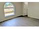 Bedroom with arched window, modern flooring, and neutral paint at 5278 Sabrina Ter, North Port, FL 34286