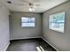 Neutral bedroom featuring luxury vinyl plank flooring, ceiling fan, and two windows at 5278 Sabrina Ter, North Port, FL 34286