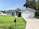 Well-maintained home featuring a paved driveway, 2-car garage, and a palm tree in the front yard at 5278 Sabrina Ter, North Port, FL 34286
