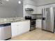 Updated kitchen with stainless steel appliances, granite countertops, and tile flooring at 5278 Sabrina Ter, North Port, FL 34286