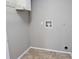 Laundry room with tile floors, a white storage cabinet, and hookups for a washer and dryer at 5278 Sabrina Ter, North Port, FL 34286