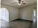 Open living room with modern flooring, ceiling fan, and arched doorway at 5278 Sabrina Ter, North Port, FL 34286