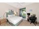 Bedroom with a queen bed, work desk, and access to a balcony at 553 Bahia Beach Blvd, Ruskin, FL 33570