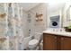 Bathroom with a shower/tub combo, wood vanity, and beach-themed decor at 553 Bahia Beach Blvd, Ruskin, FL 33570