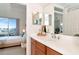 A vanity with wood cabinets and white countertop, plus a view of the bedroom at 553 Bahia Beach Blvd, Ruskin, FL 33570