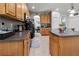 Open kitchen with an island, wood cabinets, and granite countertops at 12423 23Rd E St, Parrish, FL 34219