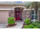 Inviting front entry with stone accents and red door at 12423 23Rd E St, Parrish, FL 34219