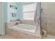 Relaxing bathroom with soaking tub and walk-in shower at 12423 23Rd E St, Parrish, FL 34219