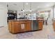 Kitchen island with seating space and stainless steel dishwasher at 12423 23Rd E St, Parrish, FL 34219