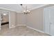 Neutral-toned dining room with chandelier and access to the kitchen at 225 Brighton Ct, Englewood, FL 34223