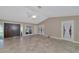 Bright living room with tile floors and sliding doors leading to the pool at 225 Brighton Ct, Englewood, FL 34223