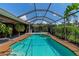 Inviting screened-in pool with a spacious deck area at 225 Brighton Ct, Englewood, FL 34223