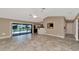 Spacious living area featuring tile floors and a view of the pool at 225 Brighton Ct, Englewood, FL 34223