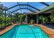 Inviting pool area with screened enclosure, spa, and ample space for relaxation at 225 Brighton Ct, Englewood, FL 34223